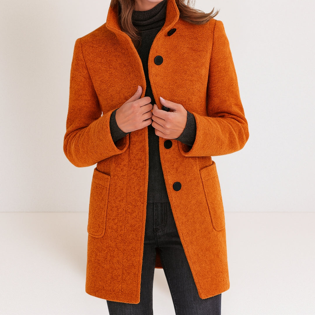 Chaqueta de mujer naranja con cuello alto, botones frontales y bolsillos tipo parche.