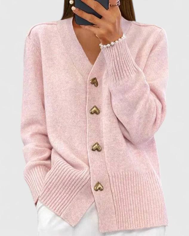Cárdigan rosa de punto con botones metálicos en forma de gota y cuello en V