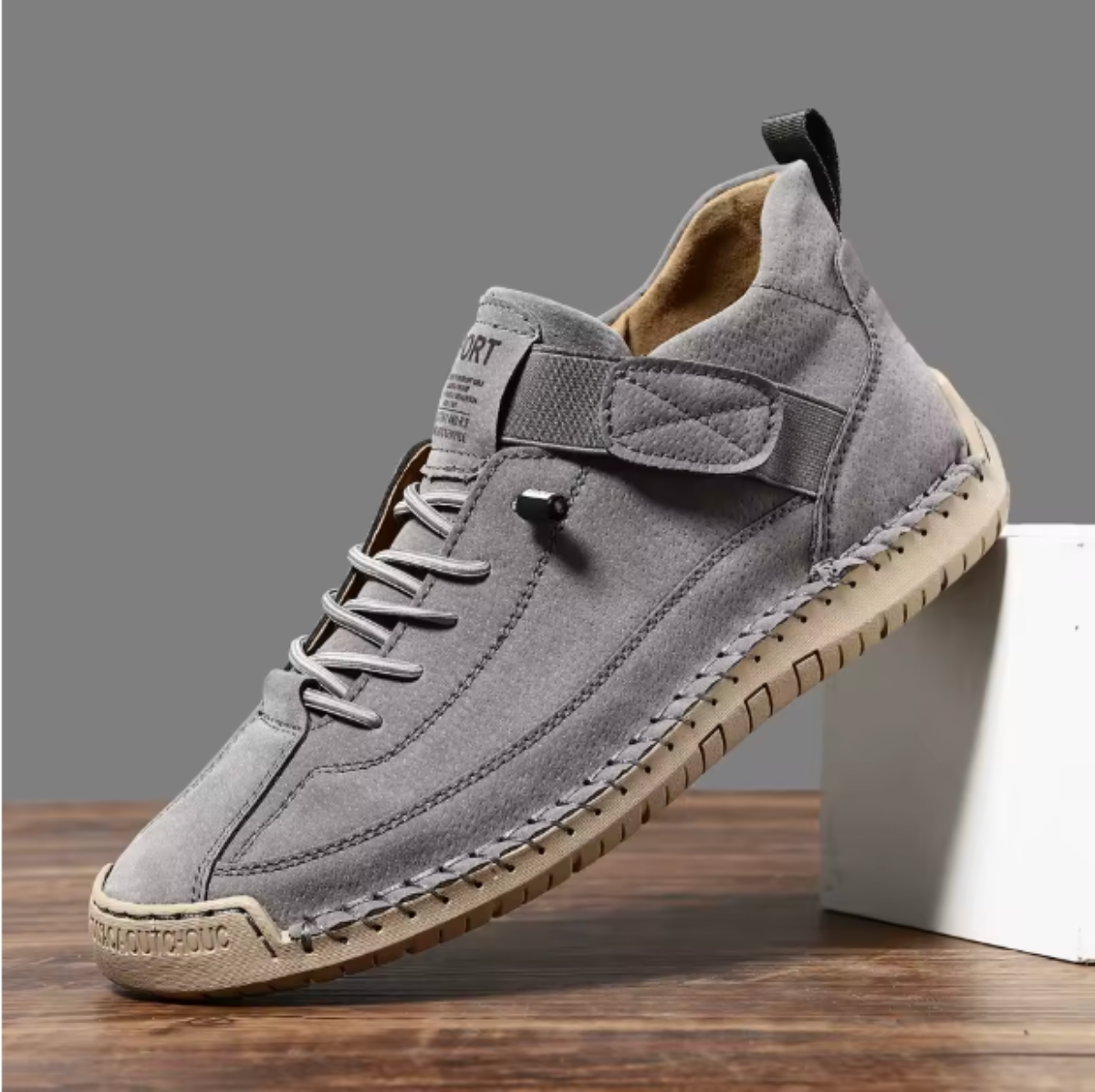 Zapatilla cómoda con soporte gris, cordones y suela de goma con costuras