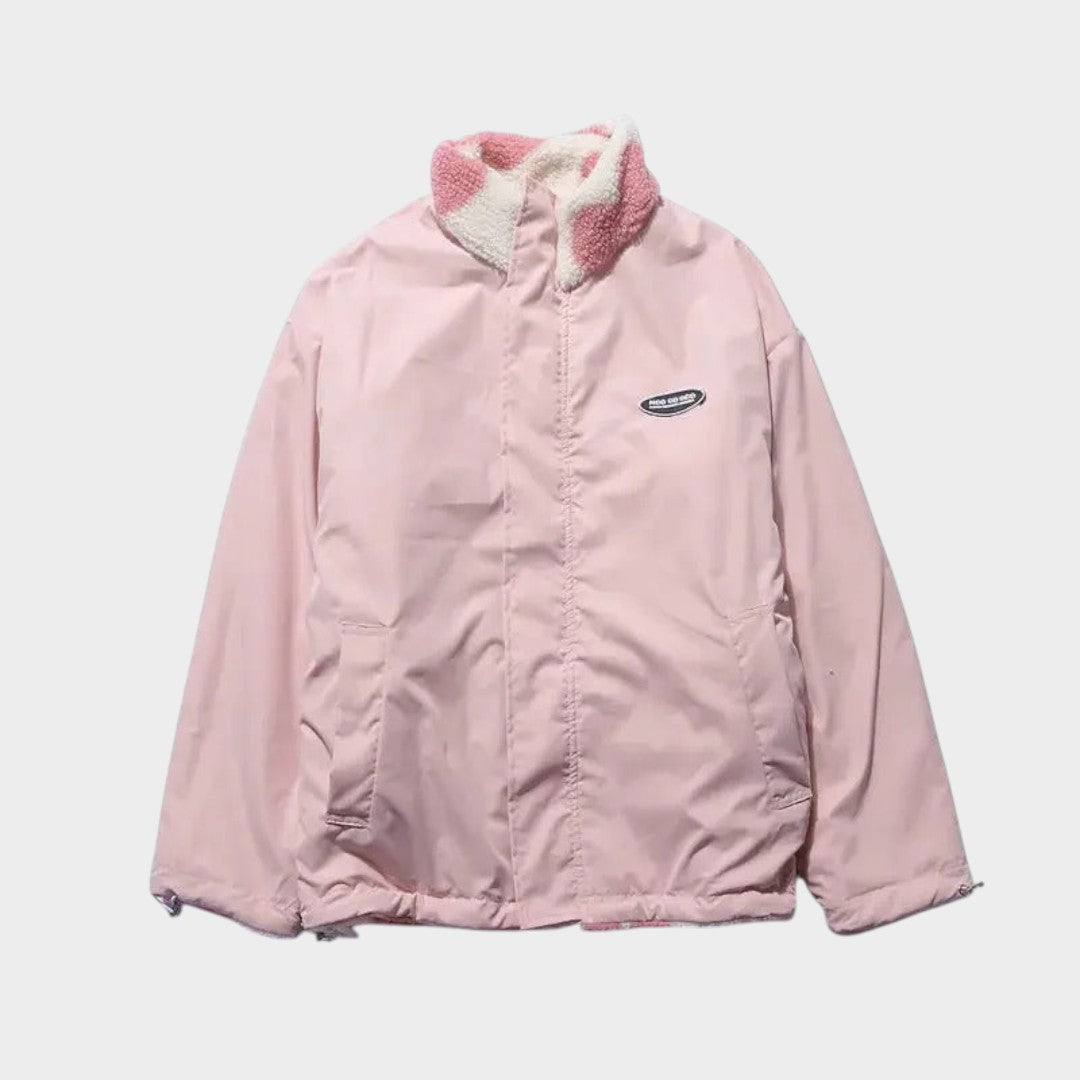 Chaqueta reversible rosa con capucha y cierre frontal, frente liso.