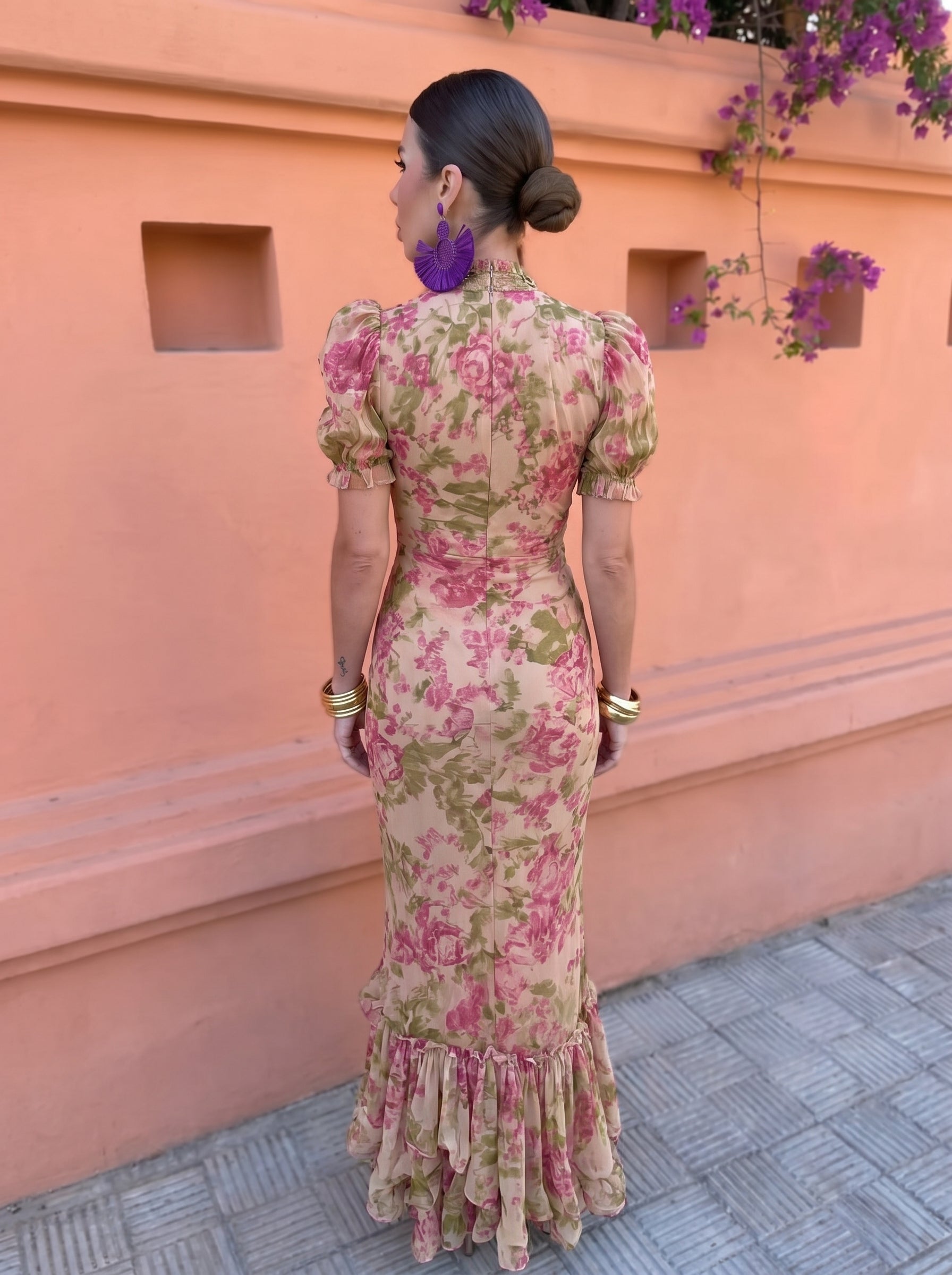 Vestido floral rosa por detrás, mangas globo y falda con volantes.