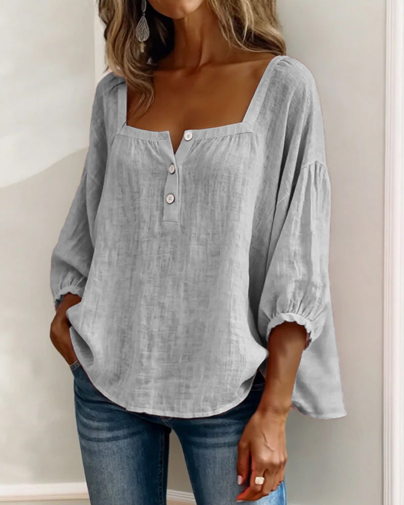 Blusa de lino gris para mujer, con botones en el pecho y mangas abullonadas.