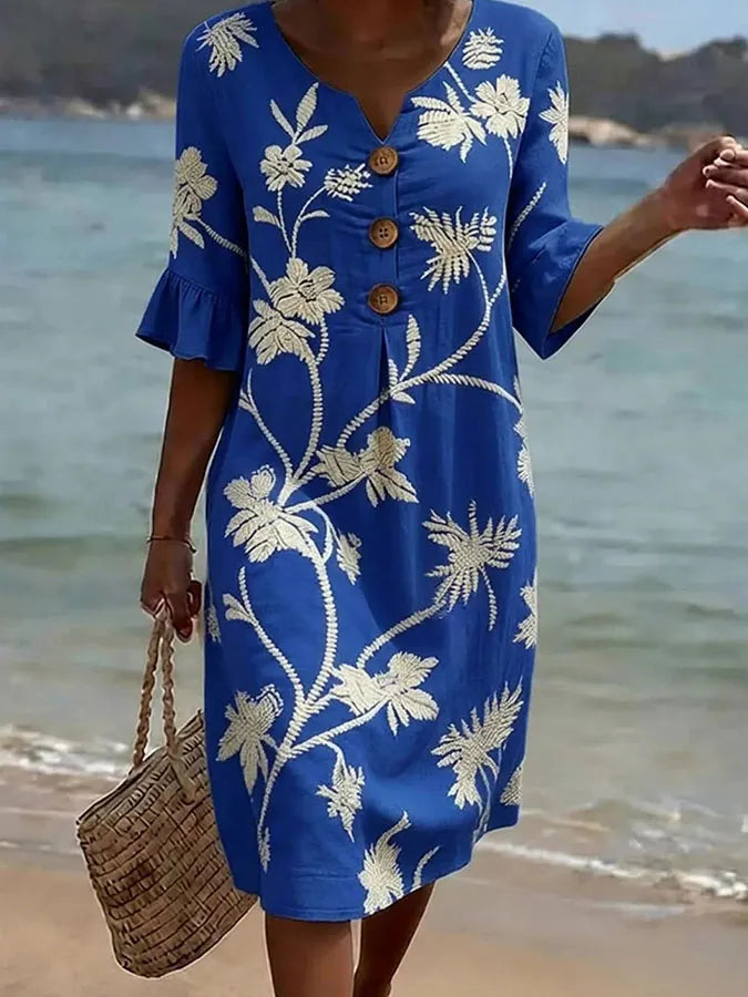 Vestido azul con estampado floral, botones y mangas con volante