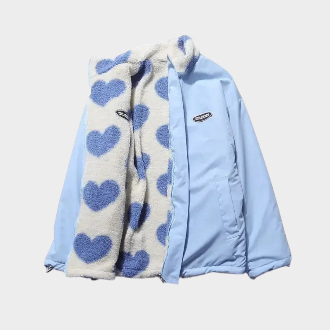 Chaqueta reversible con exterior celeste y forro polar claro con corazones azules.