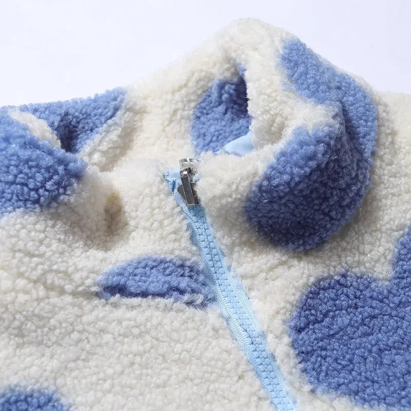 Chaqueta de borrego con corazones azules y cremallera celeste en el centro