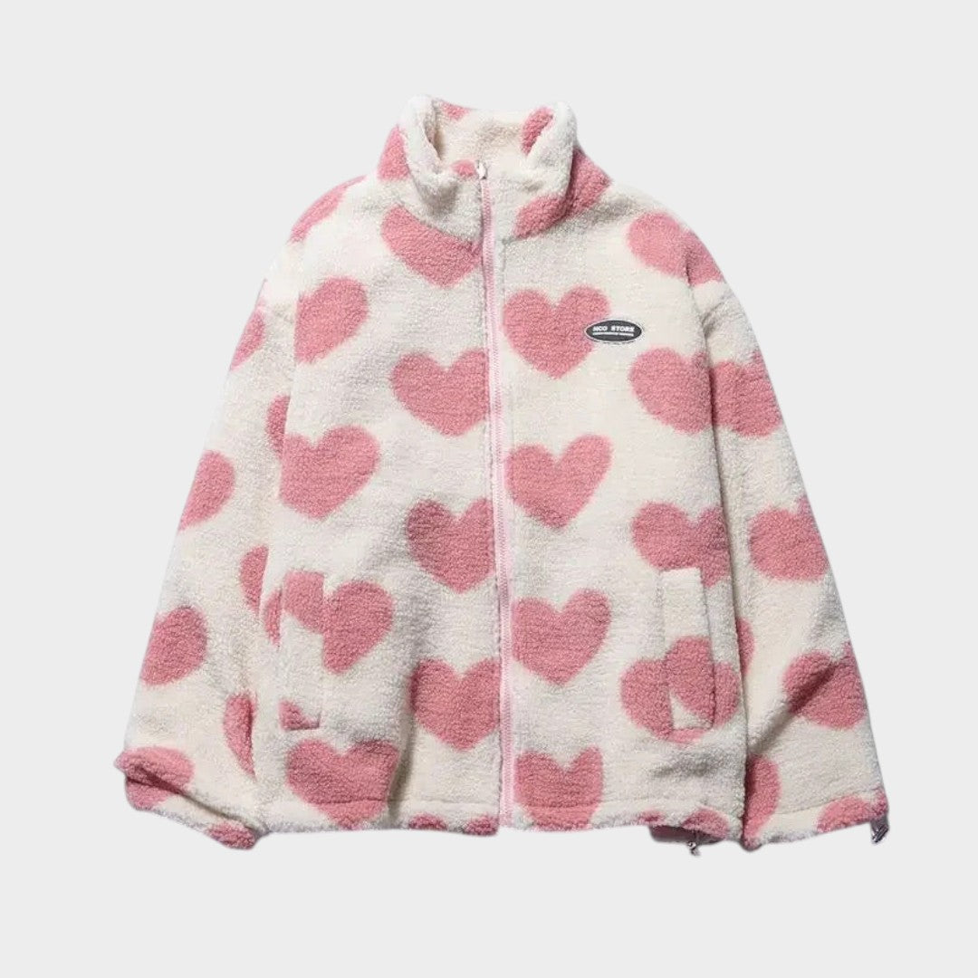 Chaqueta reversible de forro polar claro con corazones rosas y cierre frontal.