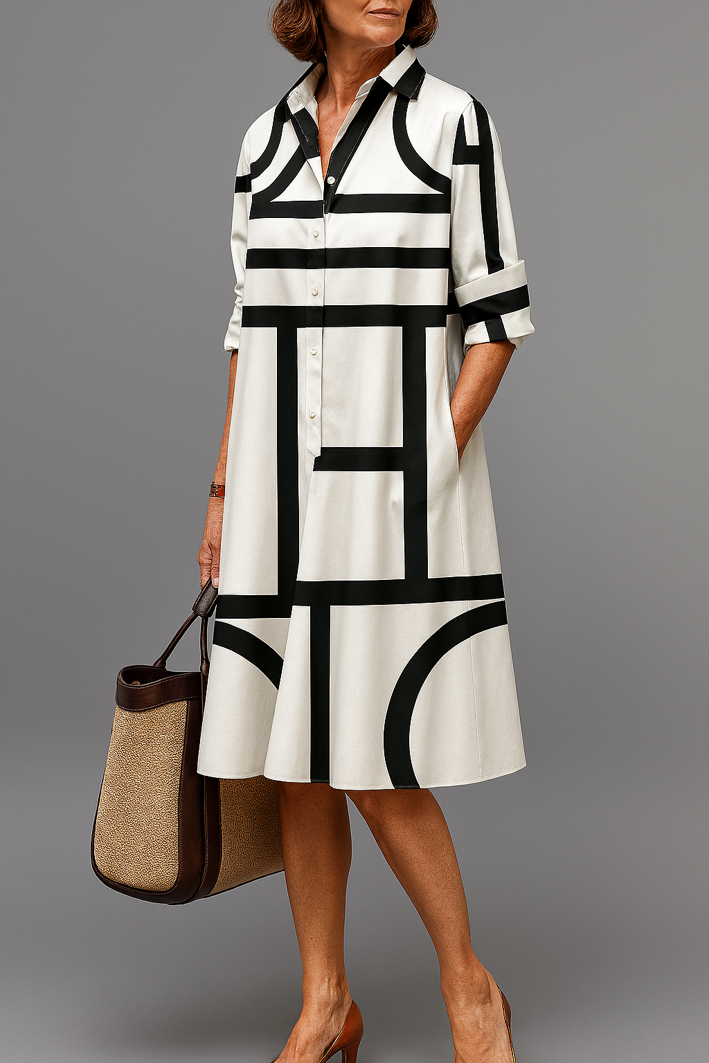 Vestido midi con estampado geométrico blanco y negro, camisa abotonada y cuello.