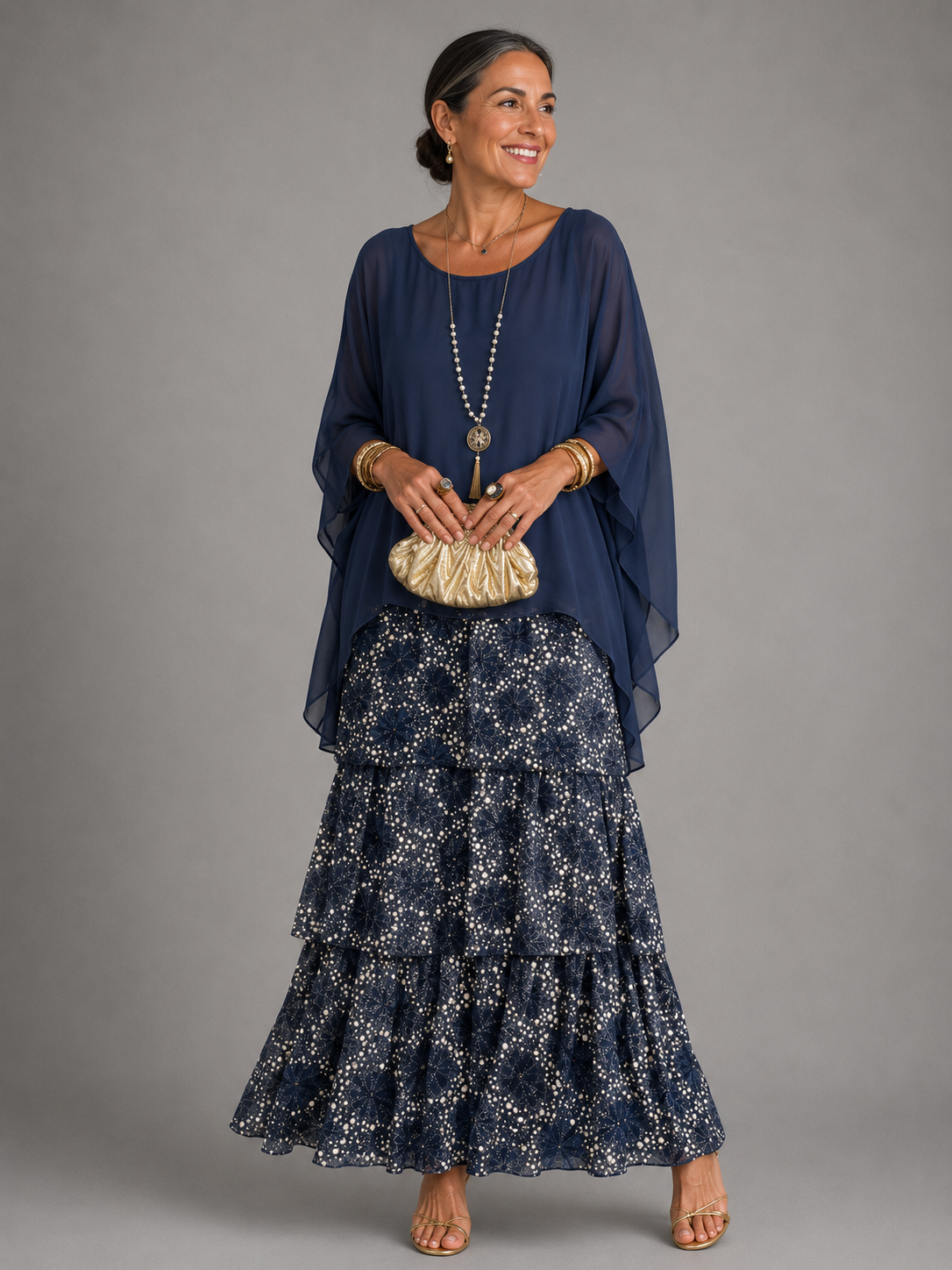 Vestido largo fluido azul marino con capa, tiras doradas y volantes con estampado