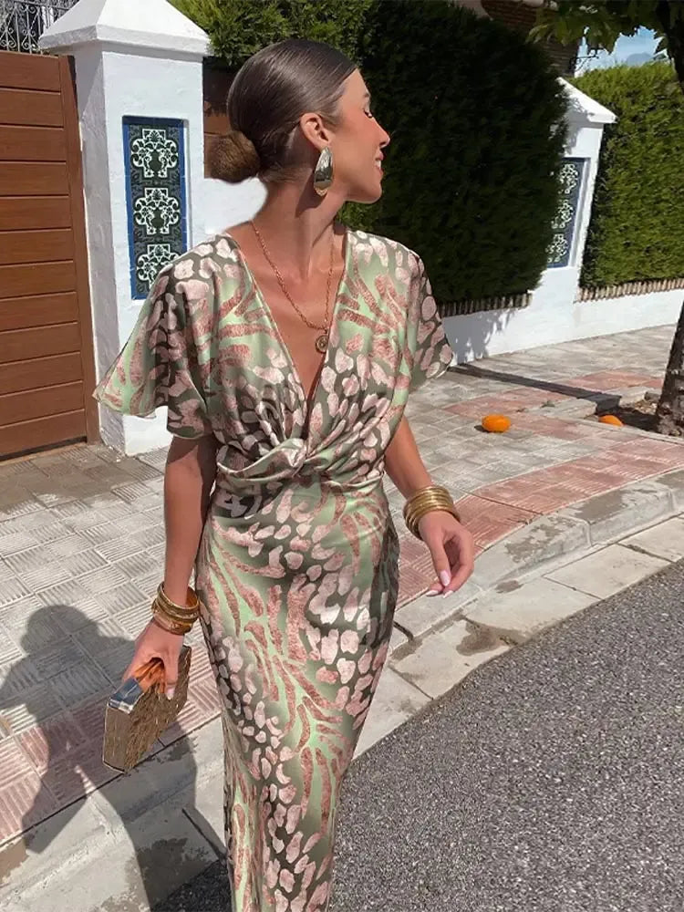 Vestido midi estampado en tonos menta y cobre, vista lateral con manga globo